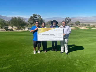 Rev. Laura Brecht accepts check from Rams Hill GM Harry Turner for the Borrego Ministers' Association. Team Members Rene Navarro and Amy Shumway are key players in Rams Hill's "For The Love of Borrego" charity program.